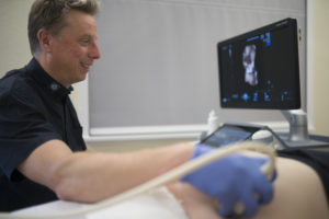 Dr Menkhaus scanning a patient